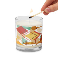 A glass  jar candle being lighted and decorated with a Southwest theme abstract illustration with geometric shapes and calming pastel colors
