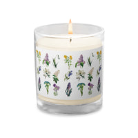 A glass jar soy wax candle with Spring flowers design all around.
