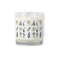 A glass jar soy wax candle with Spring flowers design all around.