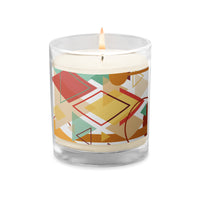 A lighted glass  jar candle decorated with a Southwest theme abstract illustration with geometric shapes and calming pastel colors