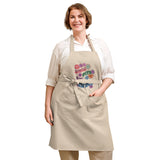 Model with cream color 100% Organic cotton apron with retro flowers design with the phrase "Small Acts Big Impact"